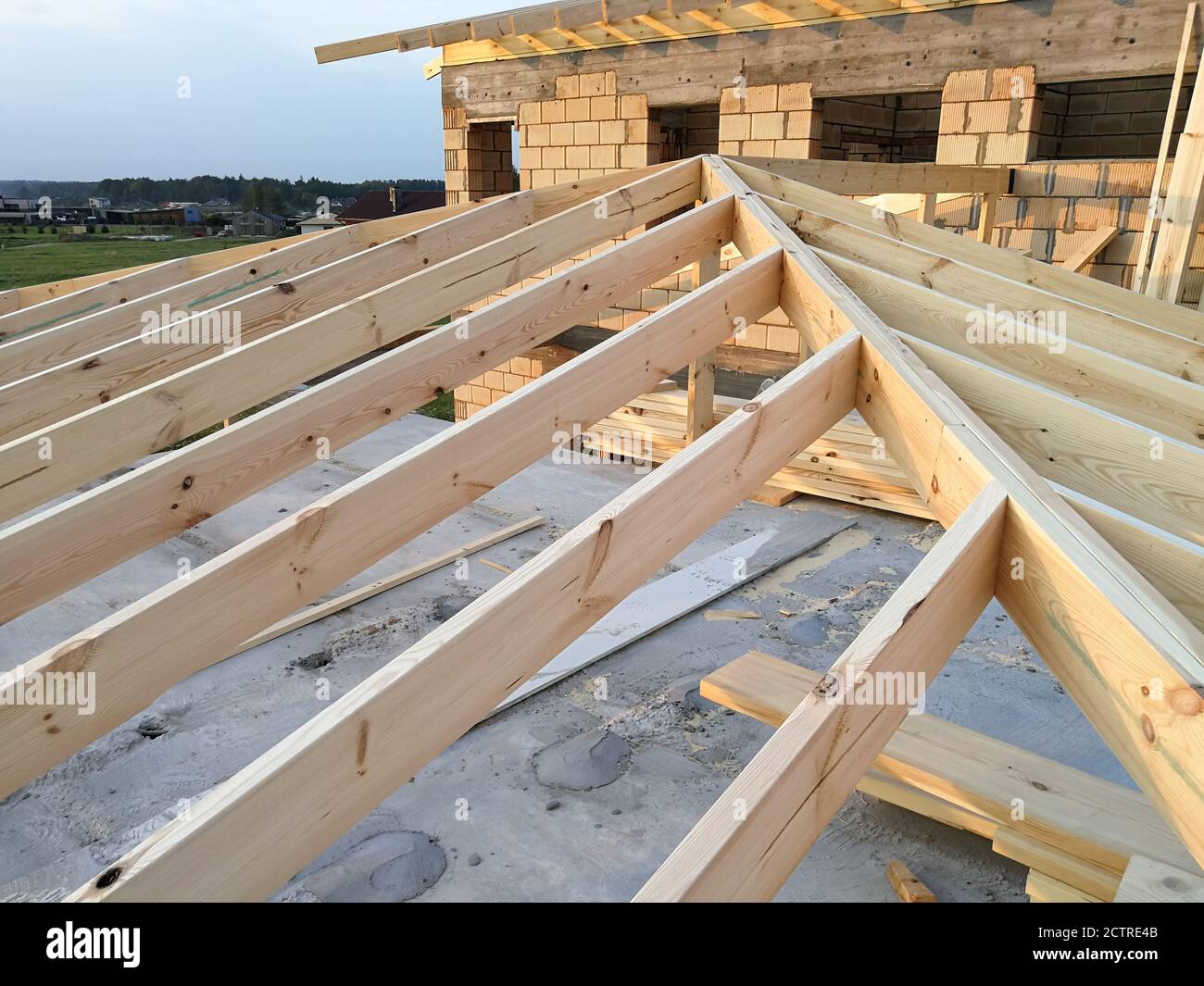 Wood girder beams for new roof construction at construction site Stock Photo