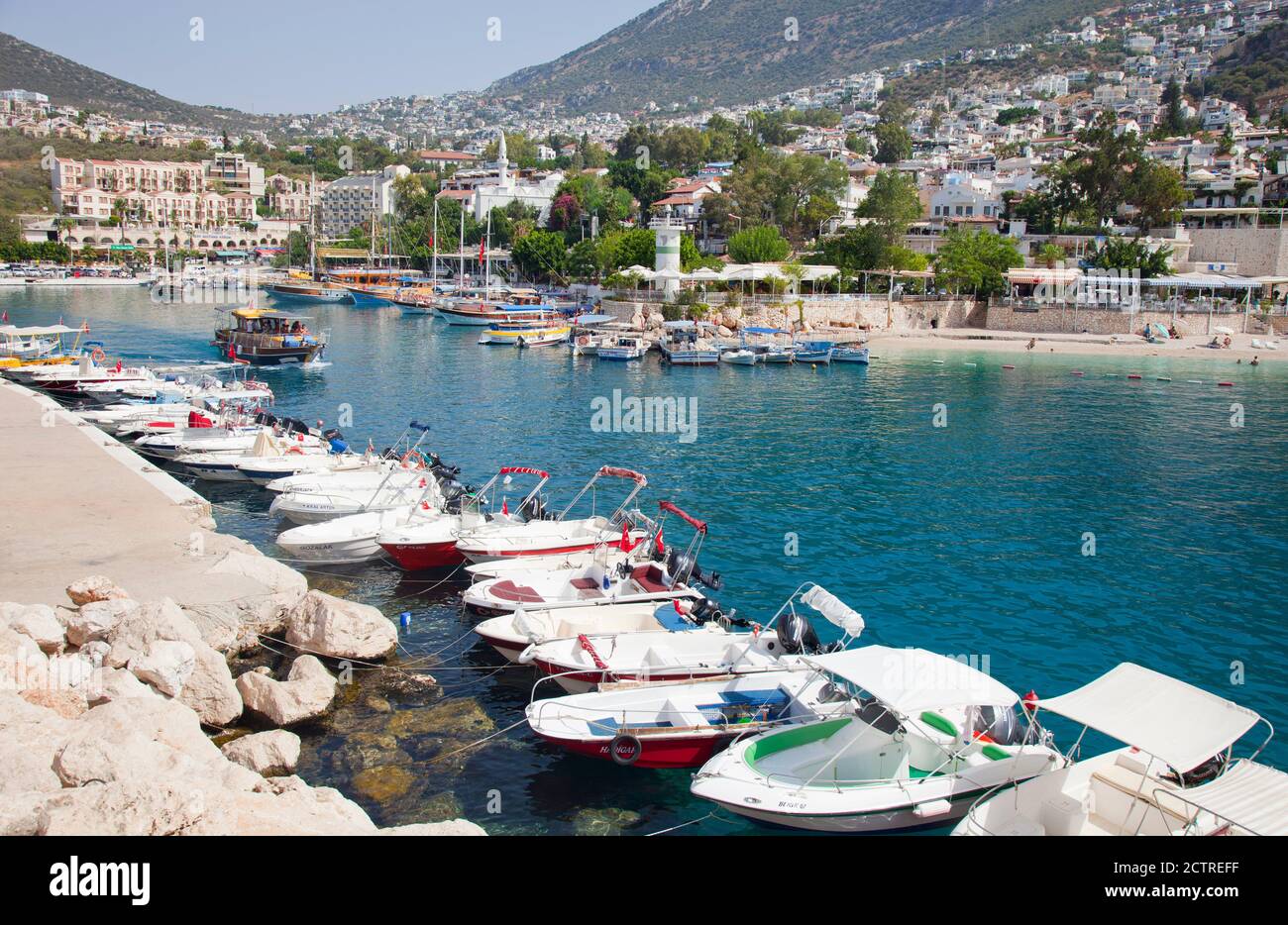 The harbour  of Kalkan in Turkey with one of the town mosques above the quayside ( centre ). Kalkan is a popular holiday destination and is located on Stock Photo
