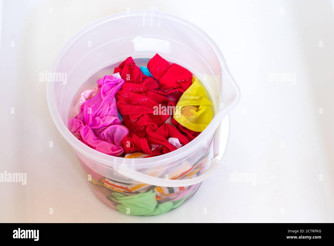 https://c8.alamy.com/comp/2CTRFKG/colorful-laundry-in-a-transparent-bucket-ready-for-washing-2CTRFKG.jpg