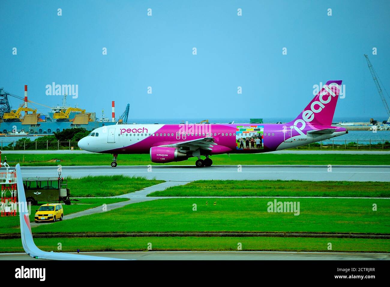 Peach, Airbus A320, JA815P, Ketsunopolis 10 Livery, Take Off, Naha Airport, Naha, Okinawa, Ryukyu Islands, Japan Stock Photo