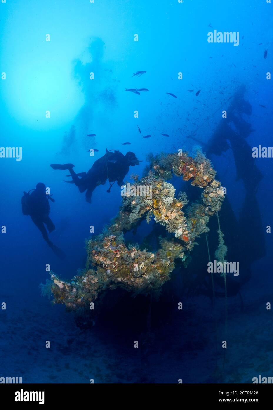 Underwater view of scuba divers at Joker sailboat shipwreck, a deep dive site in Ses Salines Natural Park (Formentera, Mediterranean Sea, Spain) Stock Photo