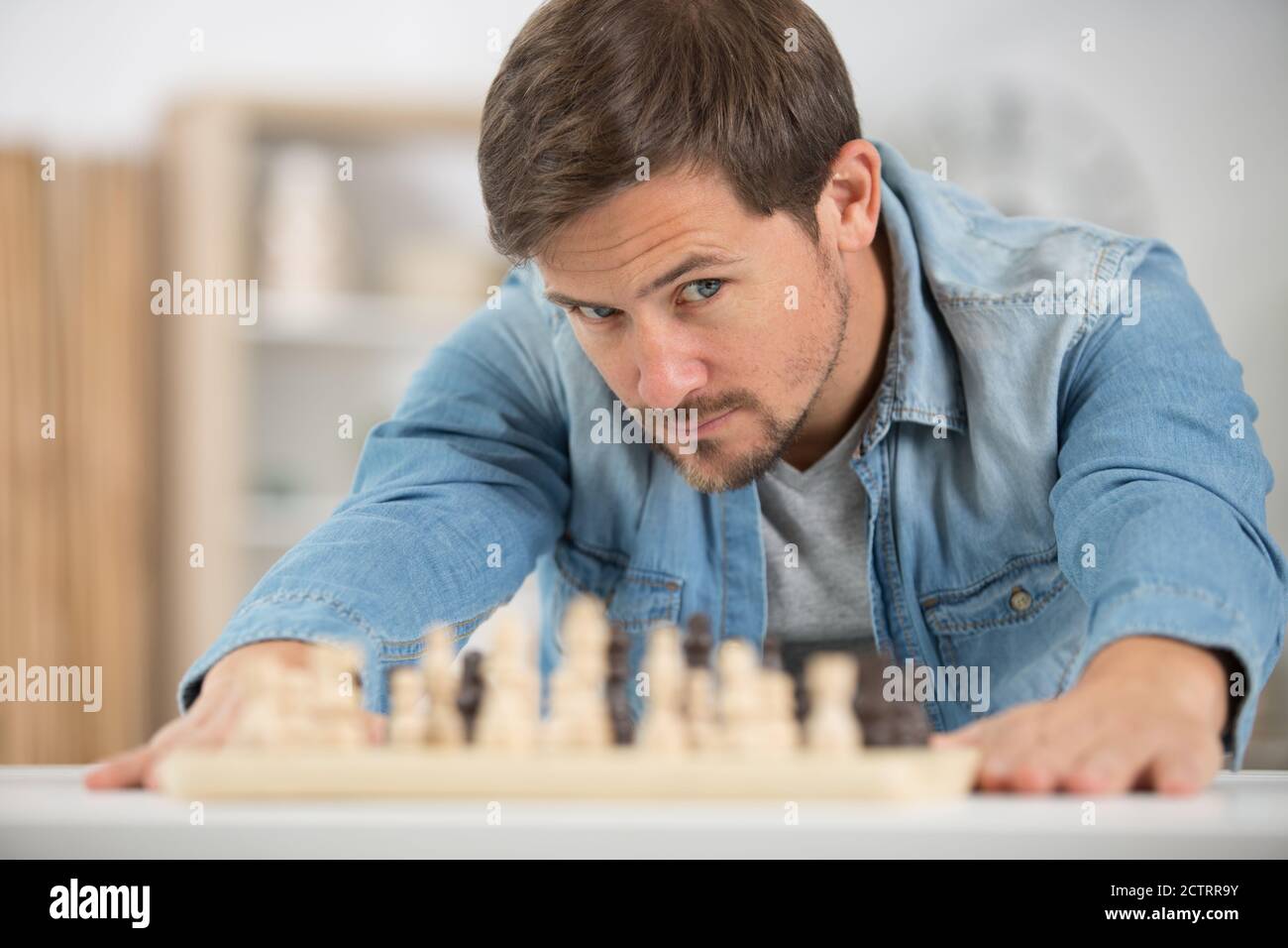 man studying the next chess move Stock Photo - Alamy