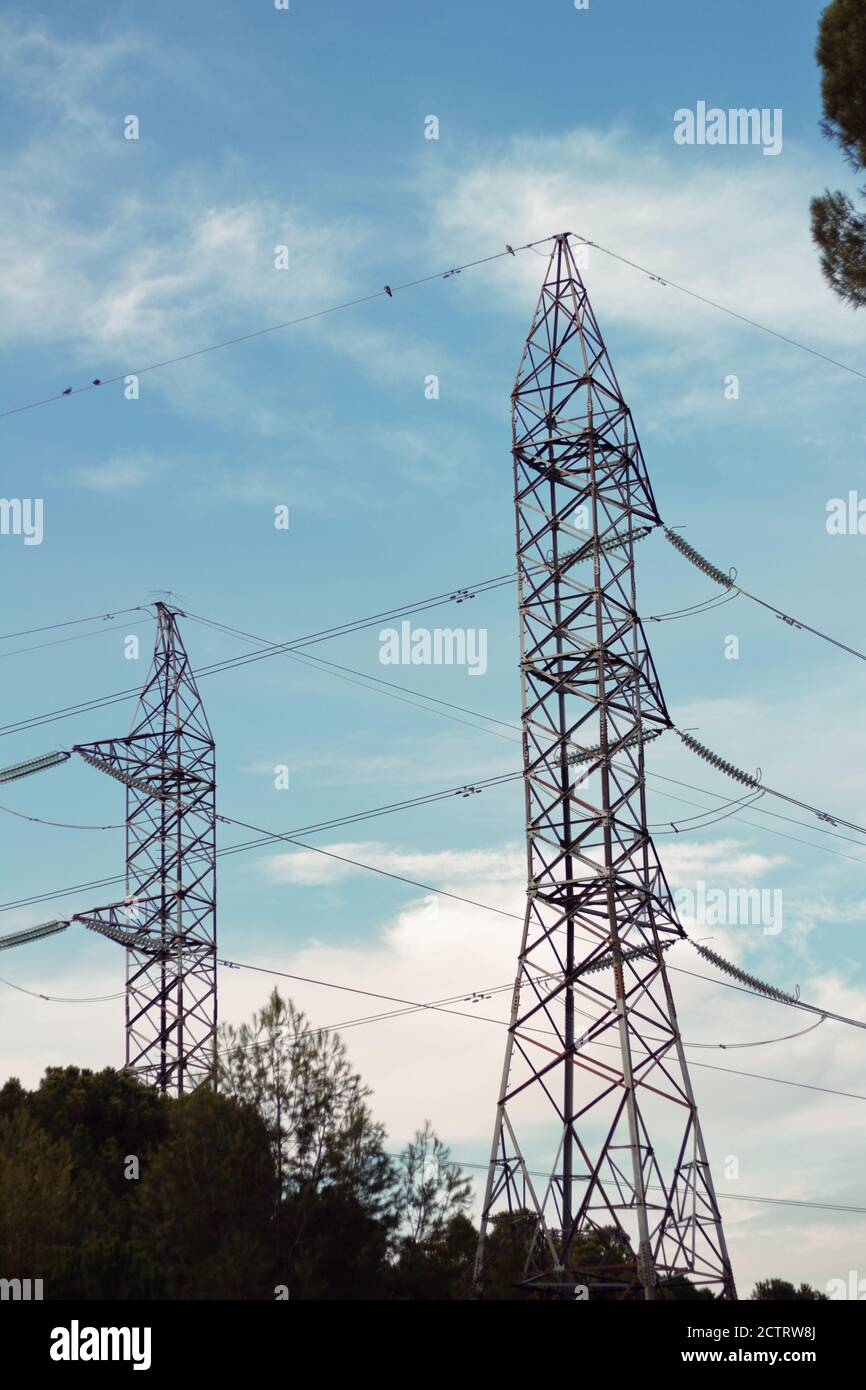 Giant Electric power transmission towers under the blue sky Stock Photo ...