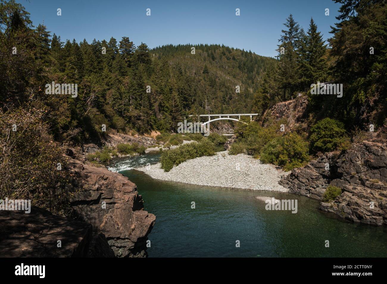 High mountain river stream during summer with tall bridge, small ...