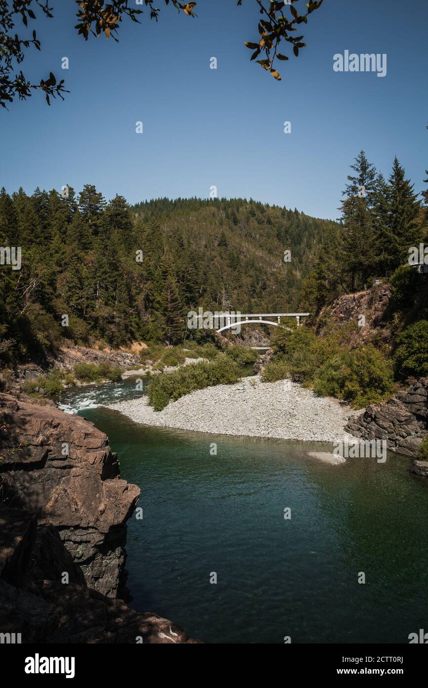 High mountain river stream during summer with tall bridge, small ...