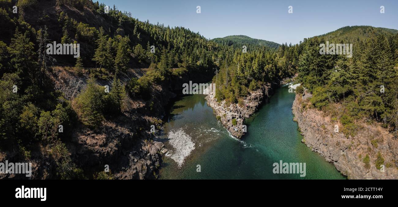 High aerial panorama view of mountain fork river stream where two rivers join together in Northern California on Smith River small ripples rocks trees Stock Photo