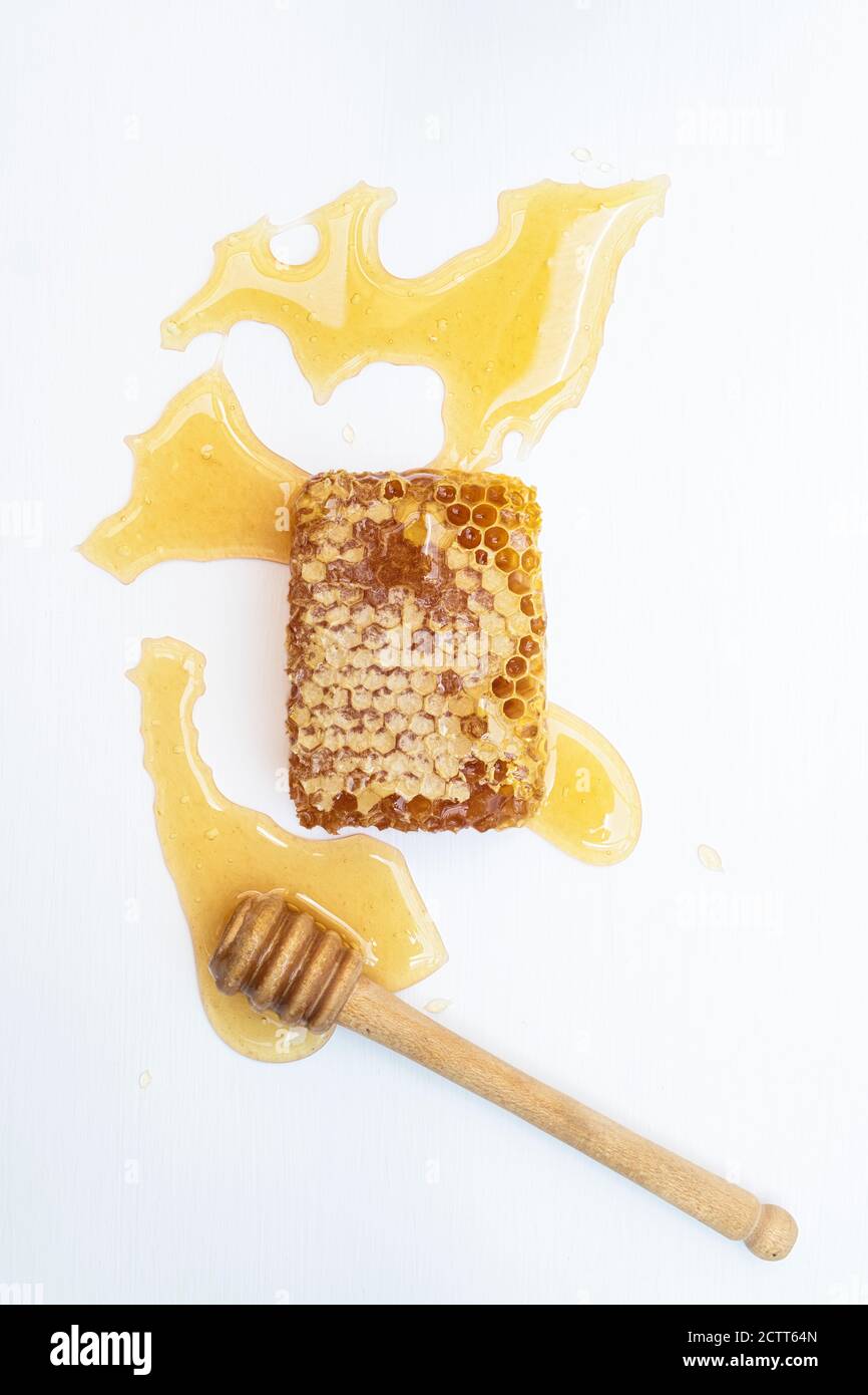 Honeycomb with a drizzler on a white background Stock Photo