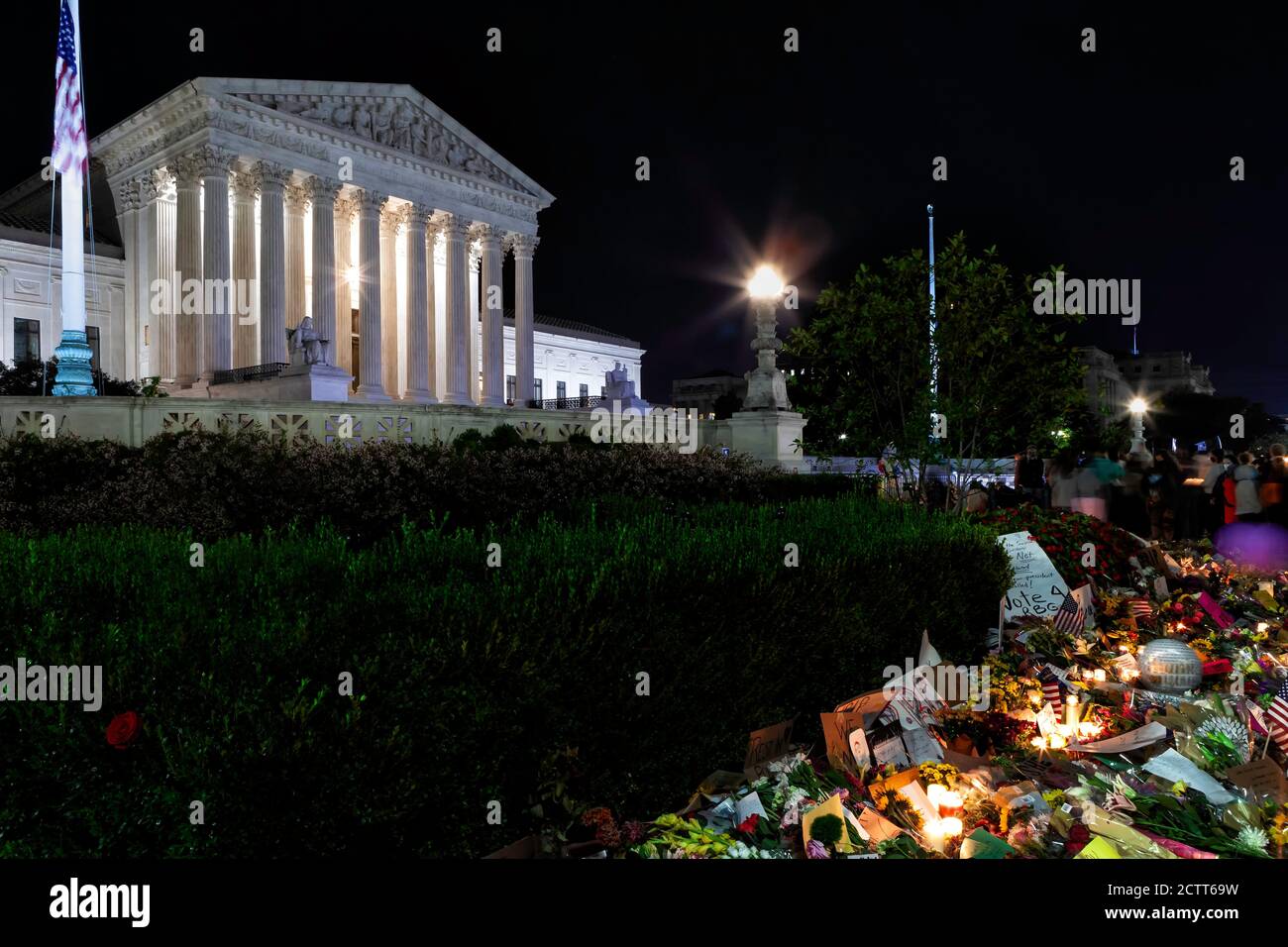 Candles and flowers lie on the sidewalk in front of the U.S. Supreme Court building in honor of Justice Ruth Bader Ginsburg, Washington, DC, USA Stock Photo