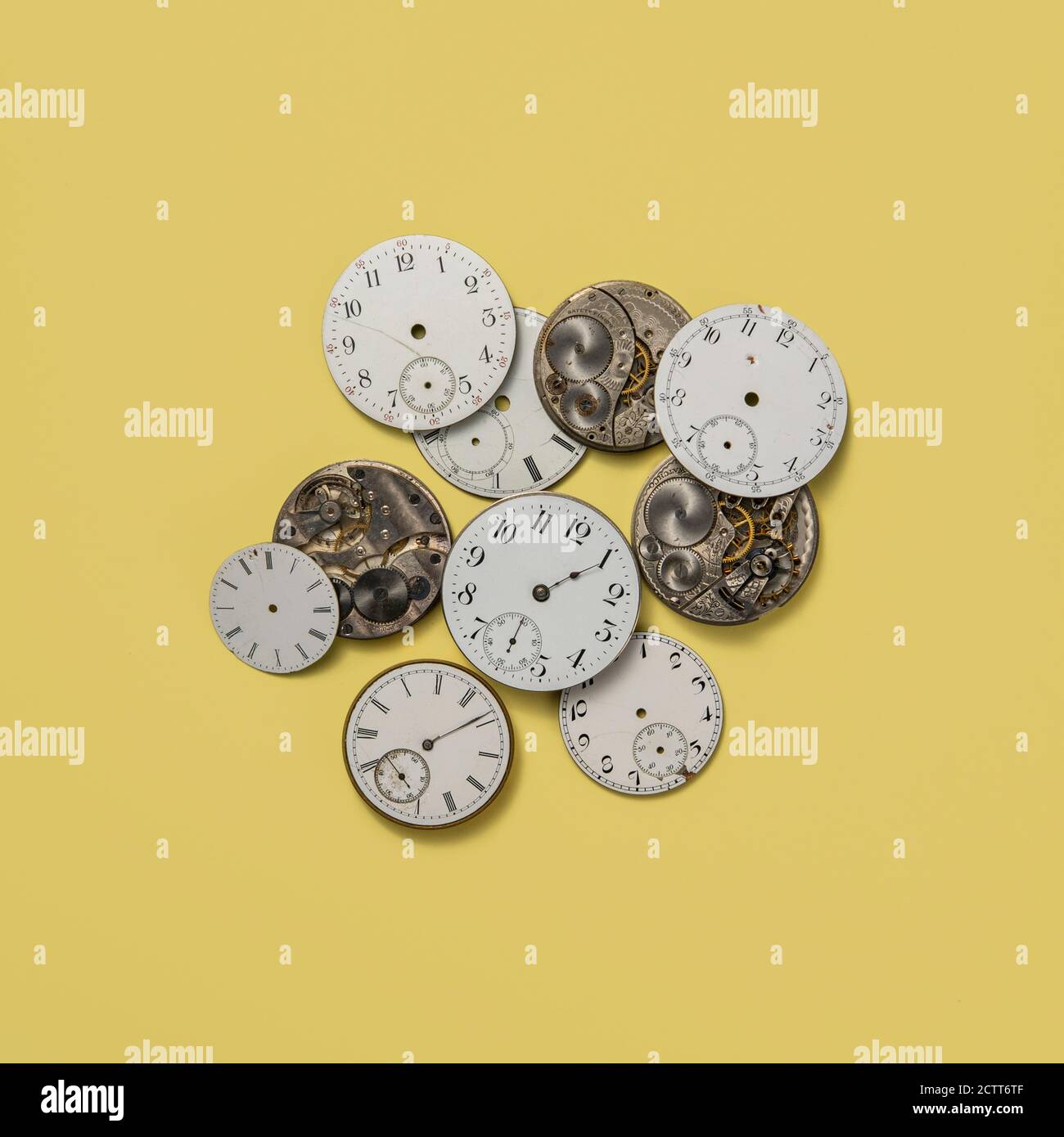 Retro watch faces and gears on yellow background Stock Photo Alamy