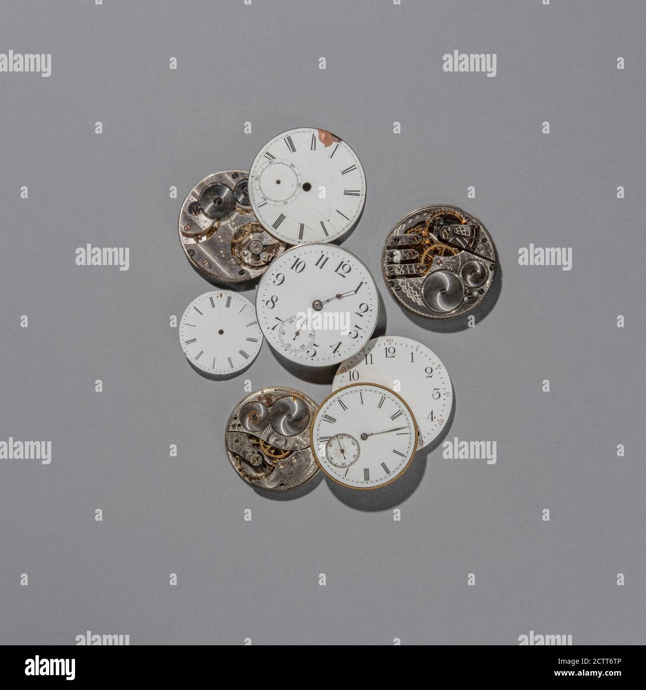 Retro watch faces and gears on grey background Stock Photo Alamy