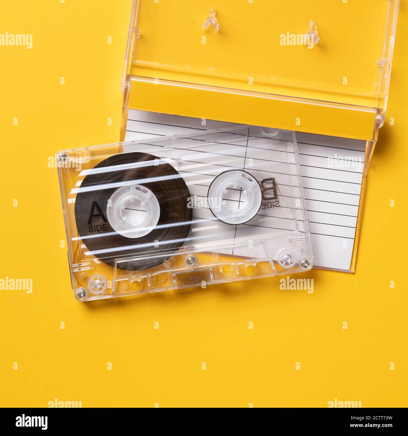 Analog audio cassette on yellow background Stock Photo