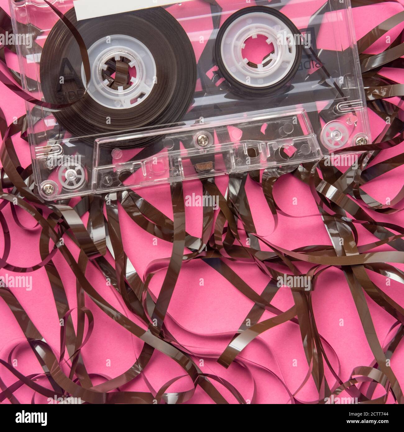 Analog audio cassette on pink background Stock Photo