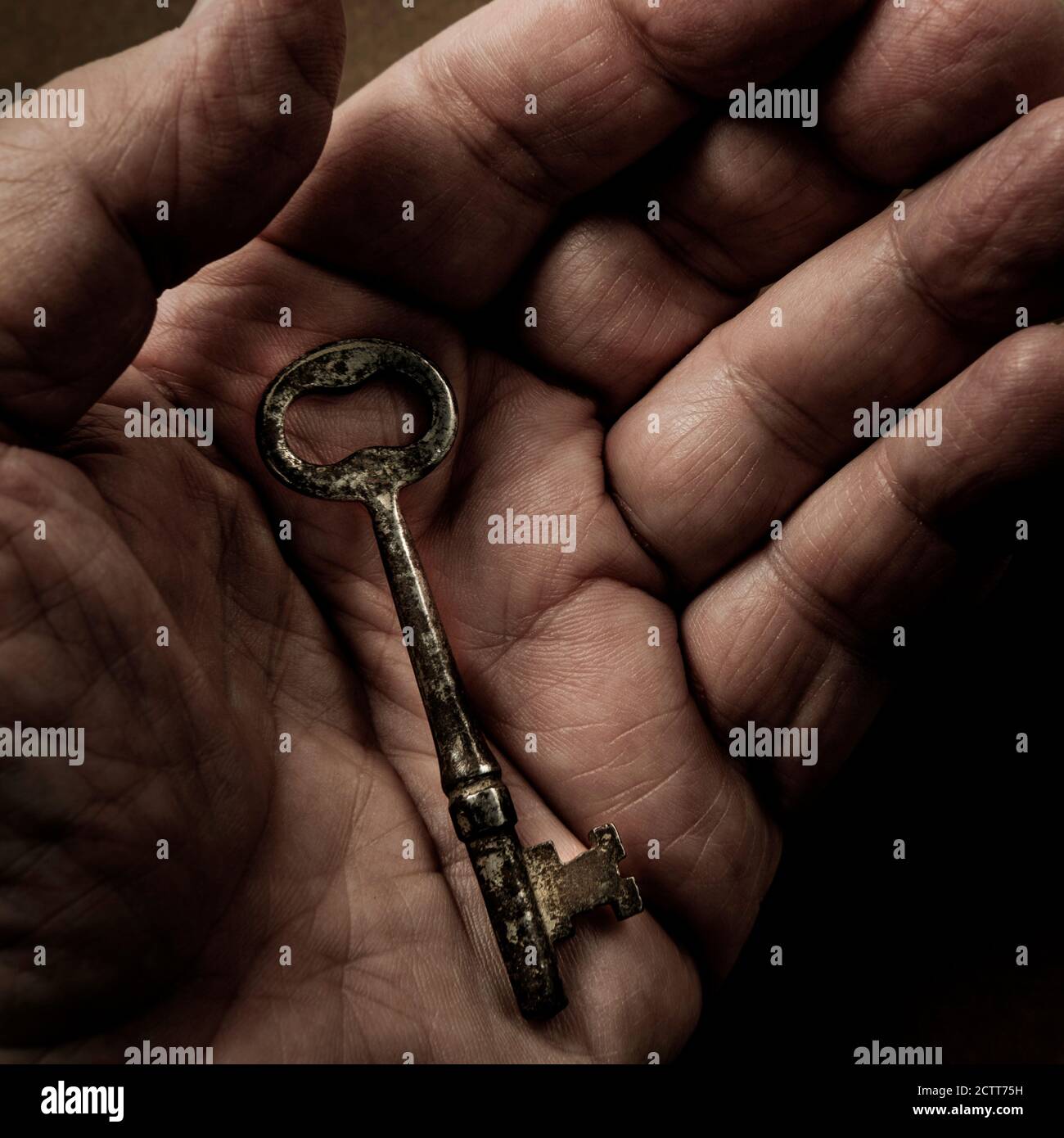 Hand holding antique key Stock Photo