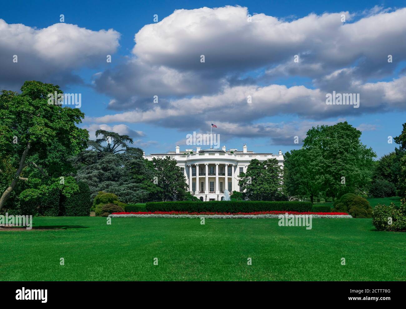 USA, Washington D.C., White house with green grass and summer sky Stock Photo