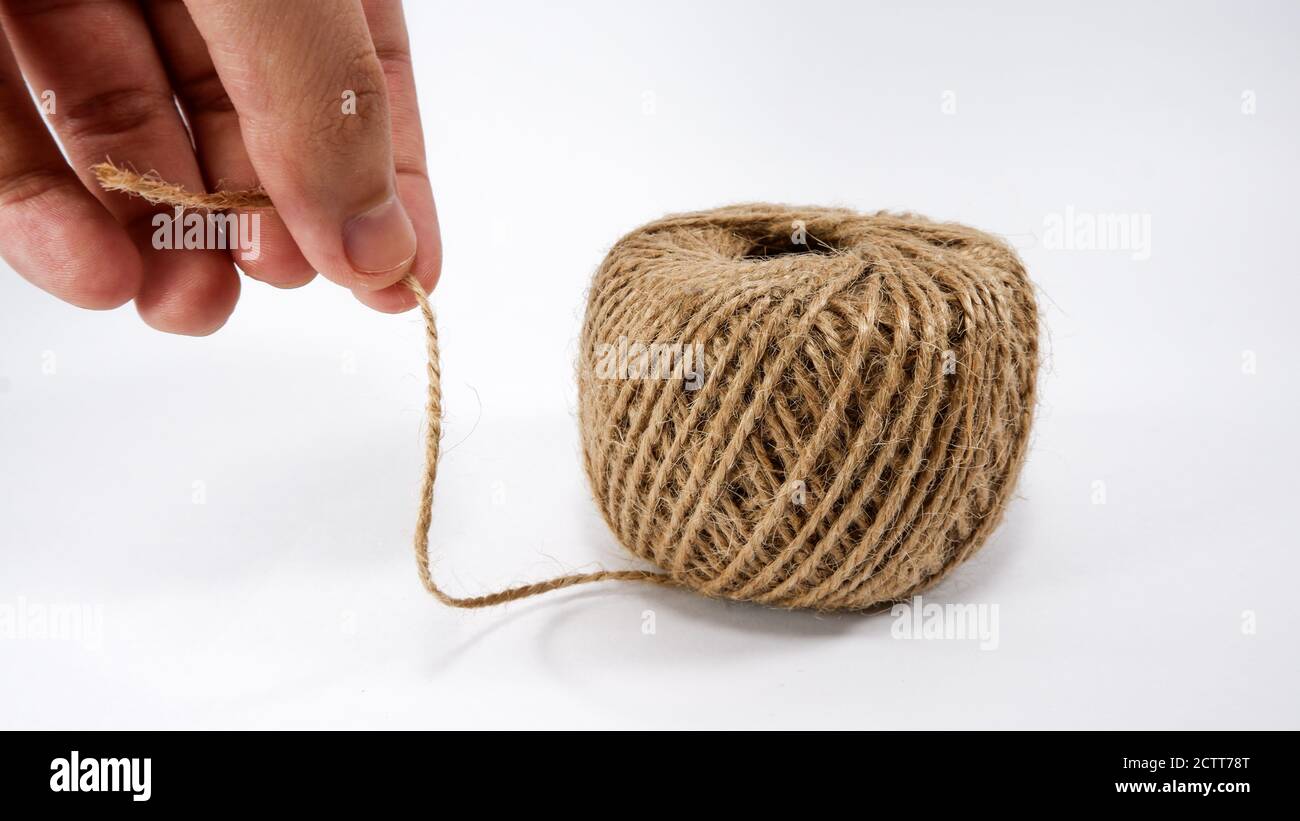 Roll of jute twine for crafting on white background Stock Photo