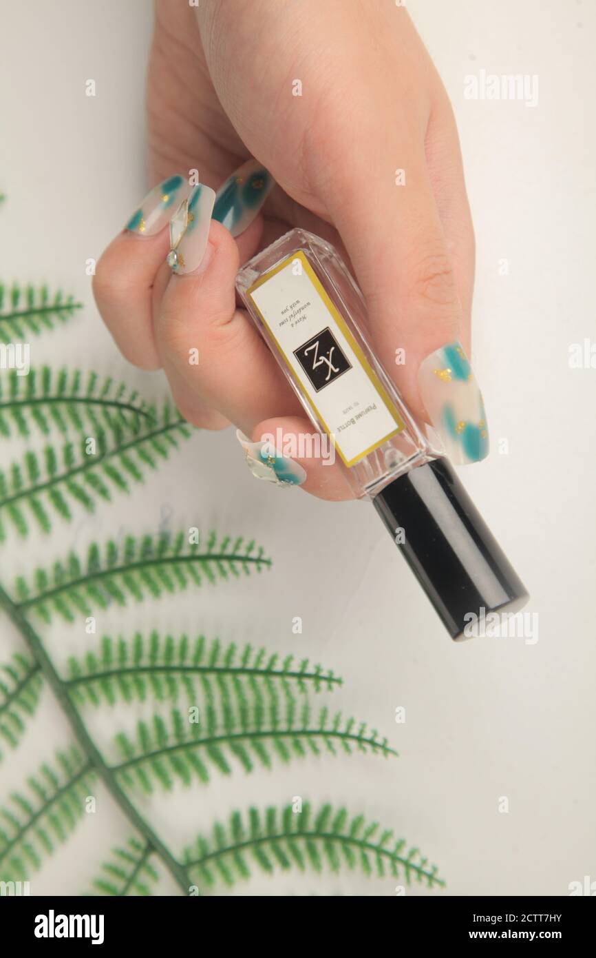 Nail polish in hand Stock Photo