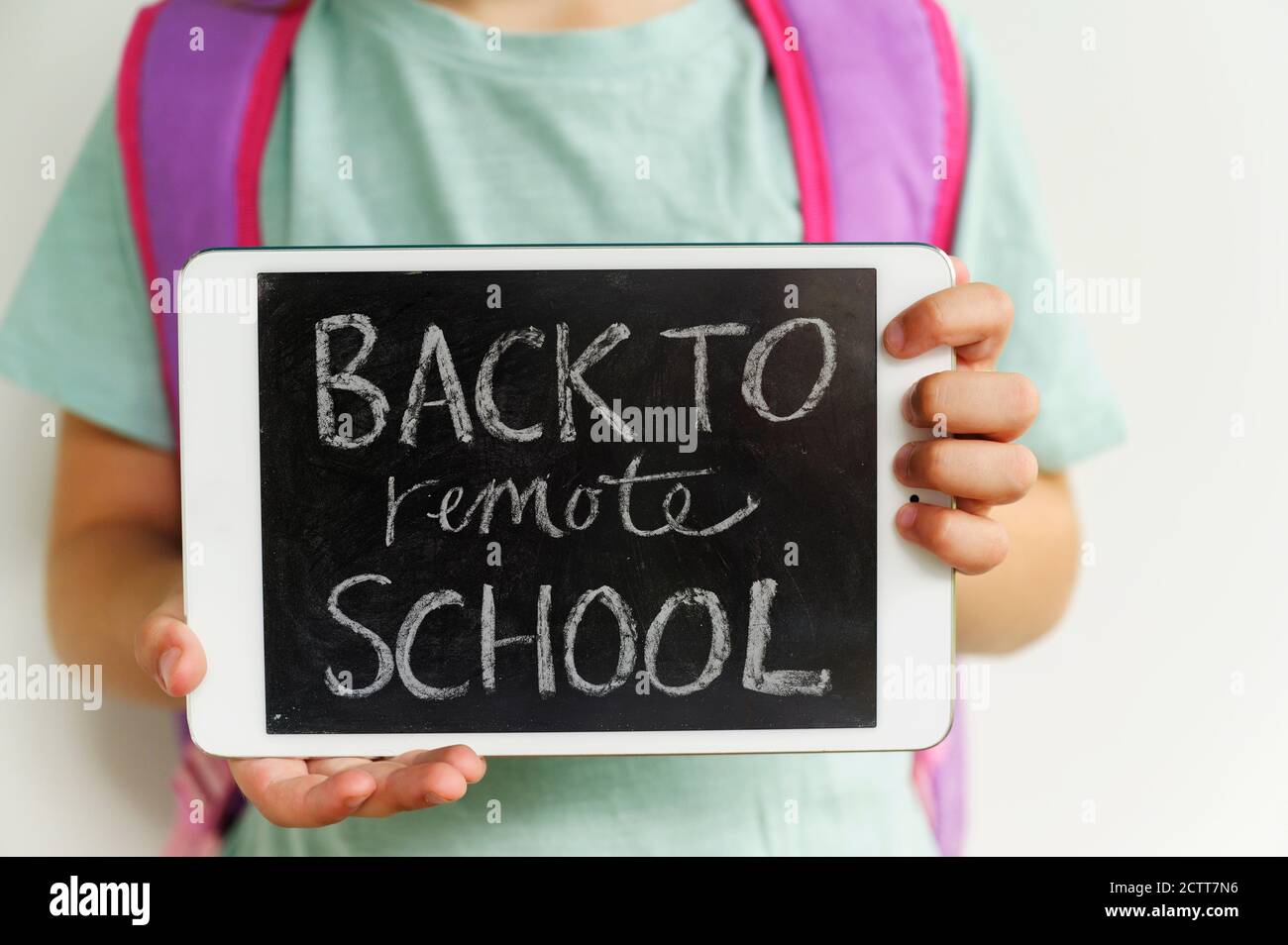 Child (6-7) holding digital tablet showing message Stock Photo