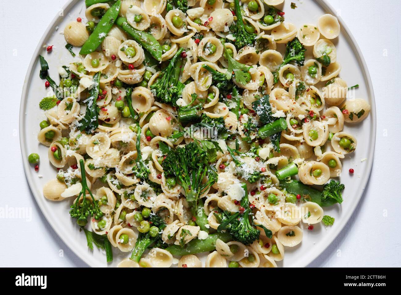 Orecchiette with broccoli and peas on plate Stock Photo