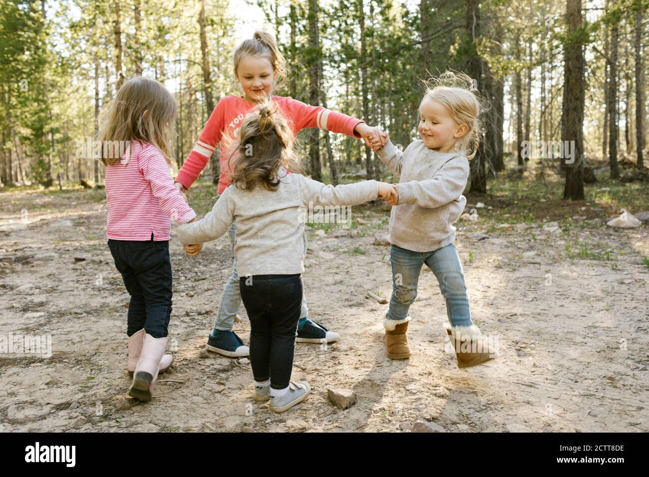 Little girls (2-3, 4-5, 6-7) holding hands and walking in circle Uinta-Wasatch-Cache National Forest Stock Photo