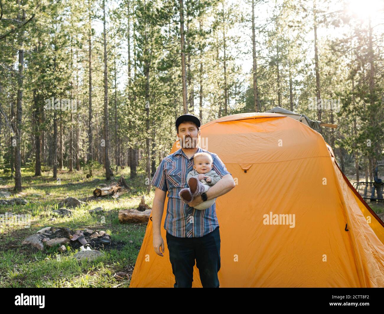Father with baby boy (6-11 Months) standing by tent in Uinta-Wasatch-Cache National Forest Stock Photo
