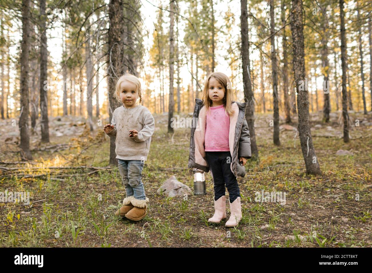 Portrait of two girls (2-3, 4-5) standing in forest, Wasatch Cache National Forest Stock Photo