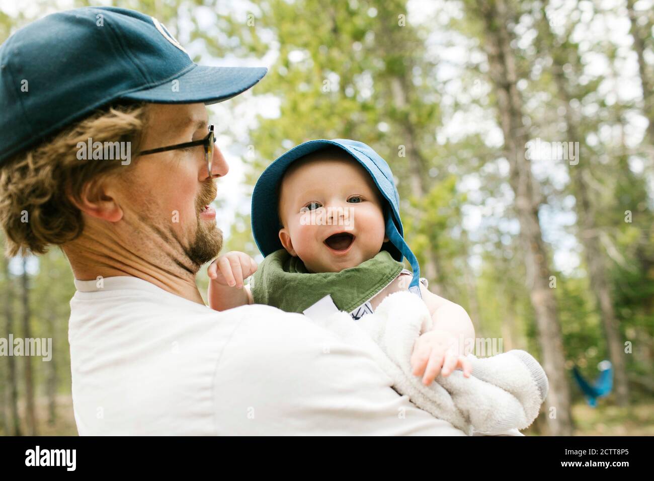 Father holding baby son (6-11 months) in forest, Wasatch-Cache National Forest Stock Photo