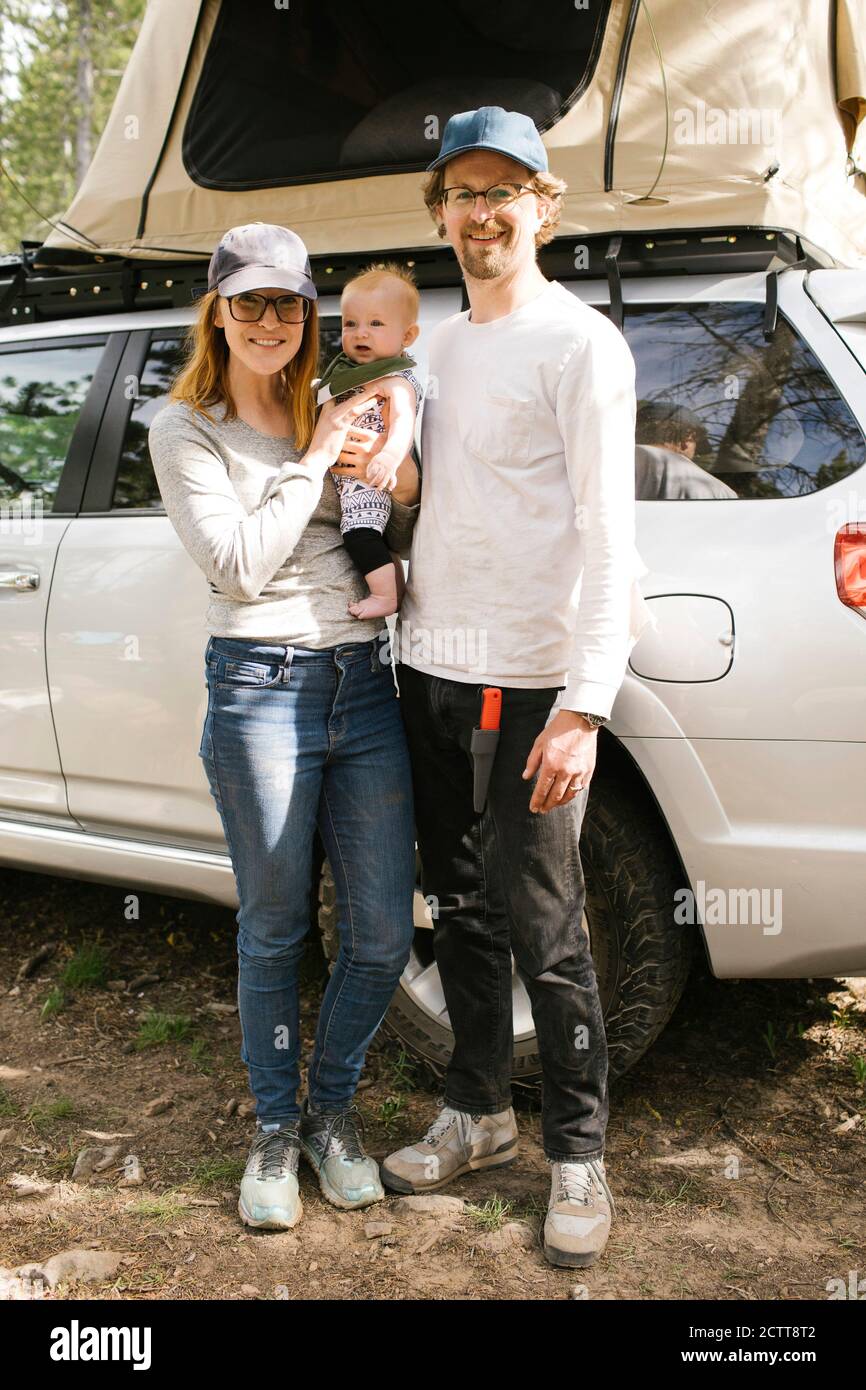 Portrait of parents with baby son (6-11 months) on camping in forest, Wasatch-Cache National Forest Stock Photo