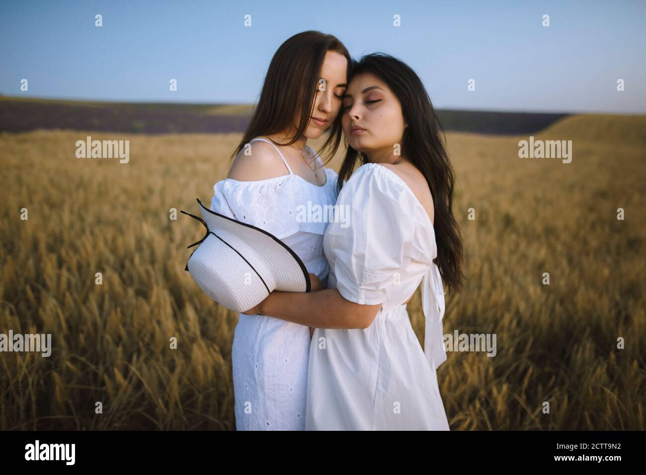 Two women in white dresses hi-res stock photography and images - Alamy