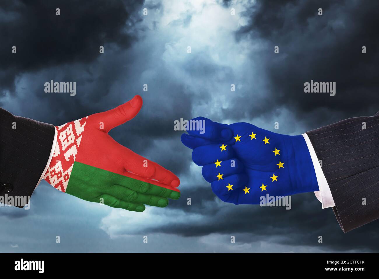 Hands on the background of a stormy sky. Concept on the topic of a proposal for friendship and difficult relations between Belarus and the European Un Stock Photo