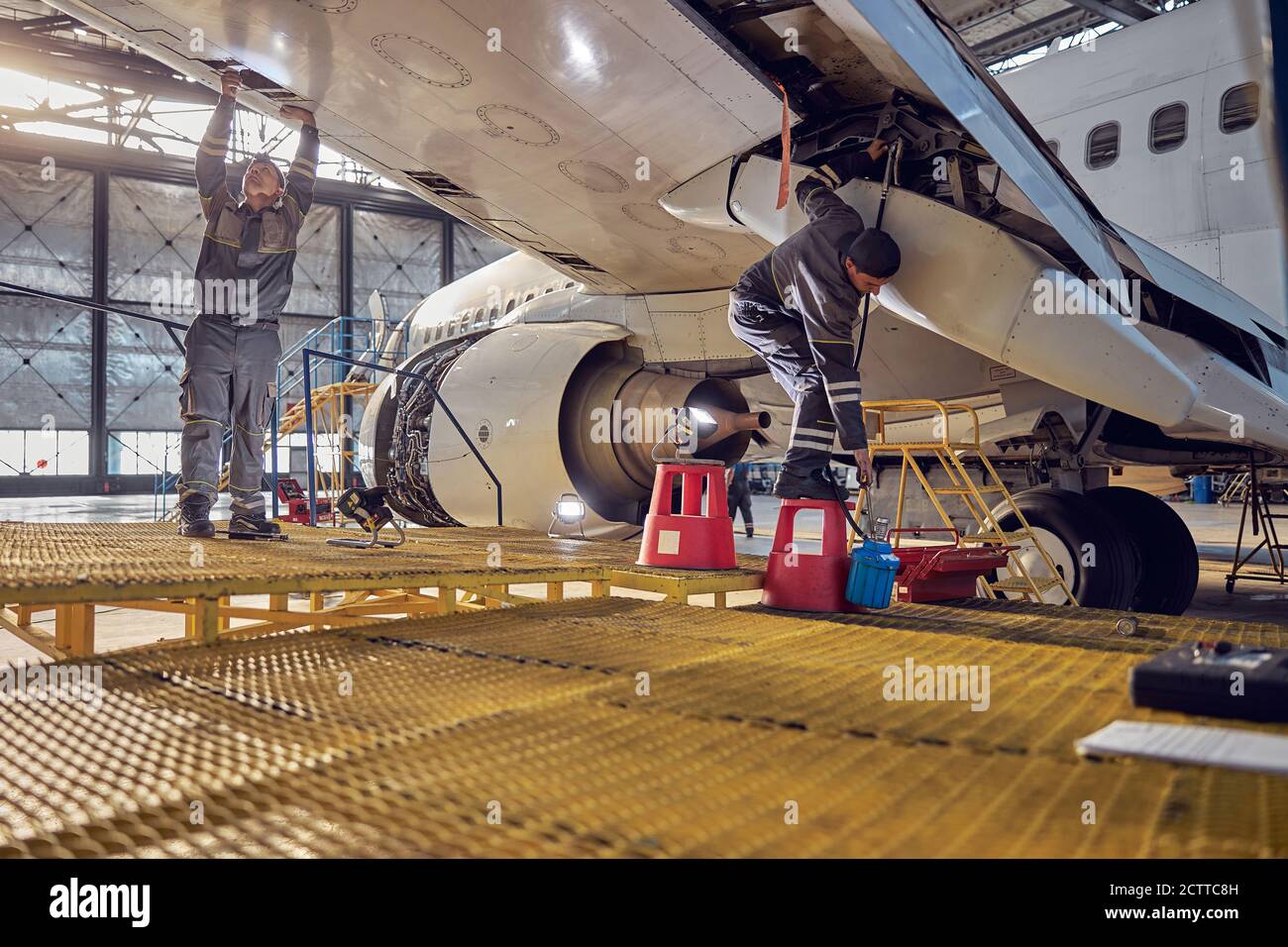 Technical aviation specialists fixing flight control surfaces Stock