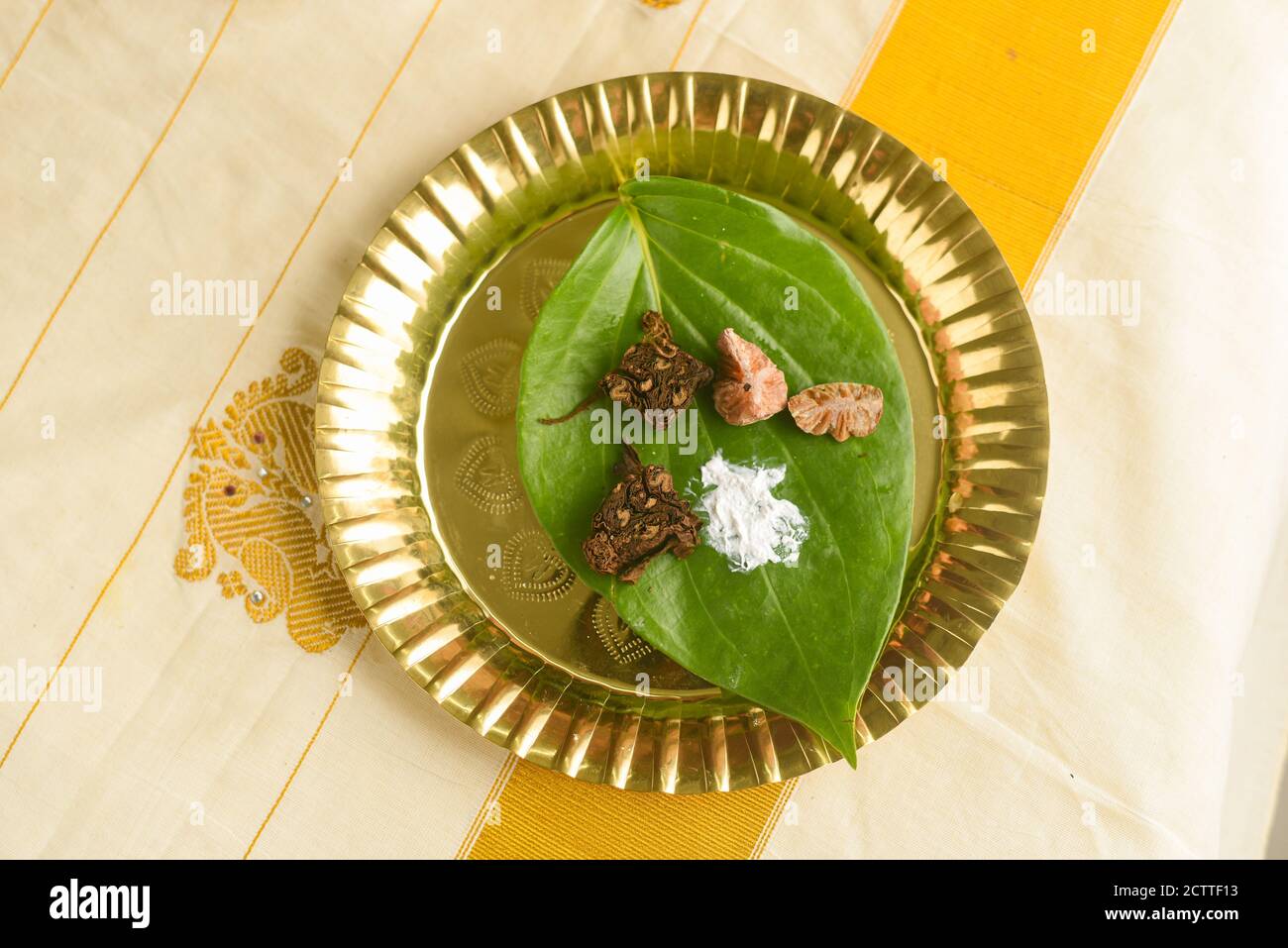 Betel leaf with areca nut paan masala, Kerala Onam festival giving Dakshina, Indian culture monastery, temple, spiritual guide or after a ritual Pooja Stock Photo