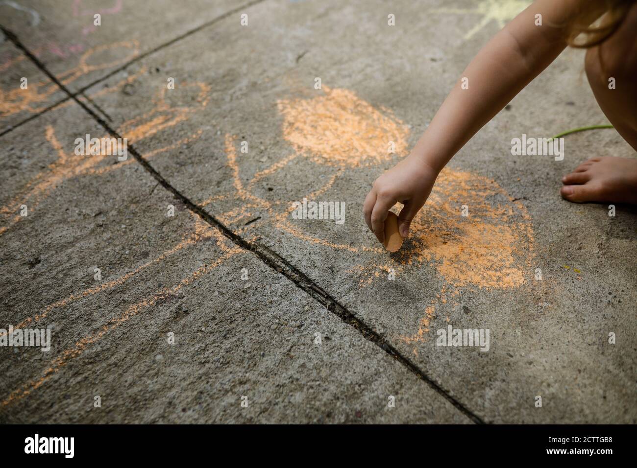Shallow depth of field (selective focus) image with a girl drawing on ...