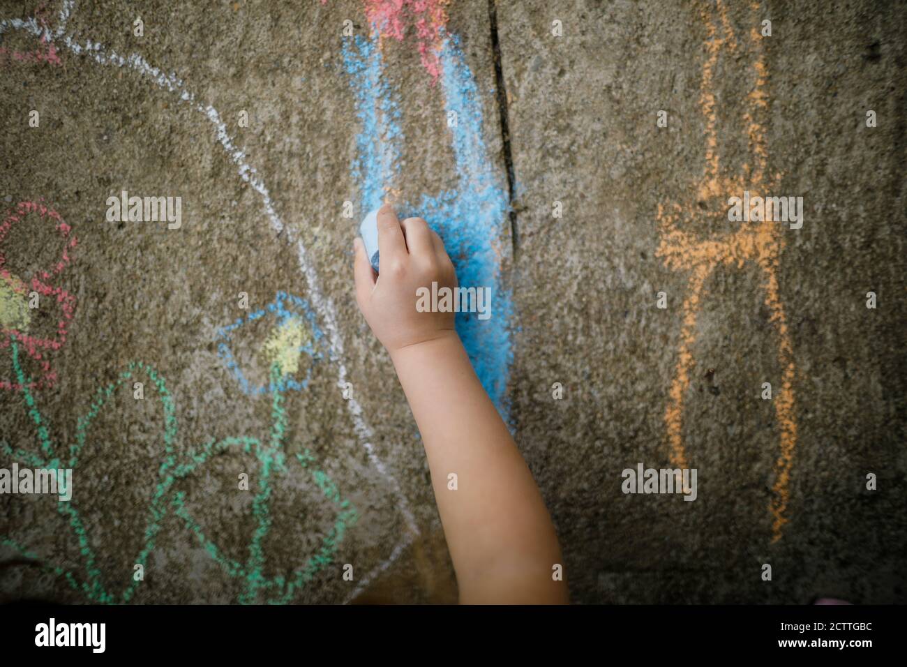Shallow depth of field (selective focus) image with a girl drawing on ...