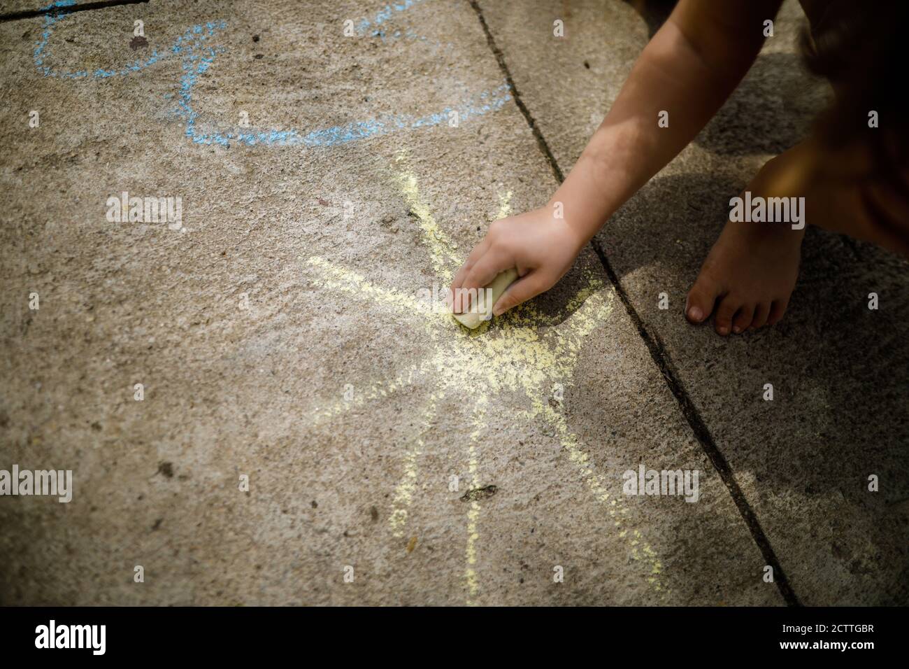 Children drawing on a pavement with chalk hi-res stock photography and ...