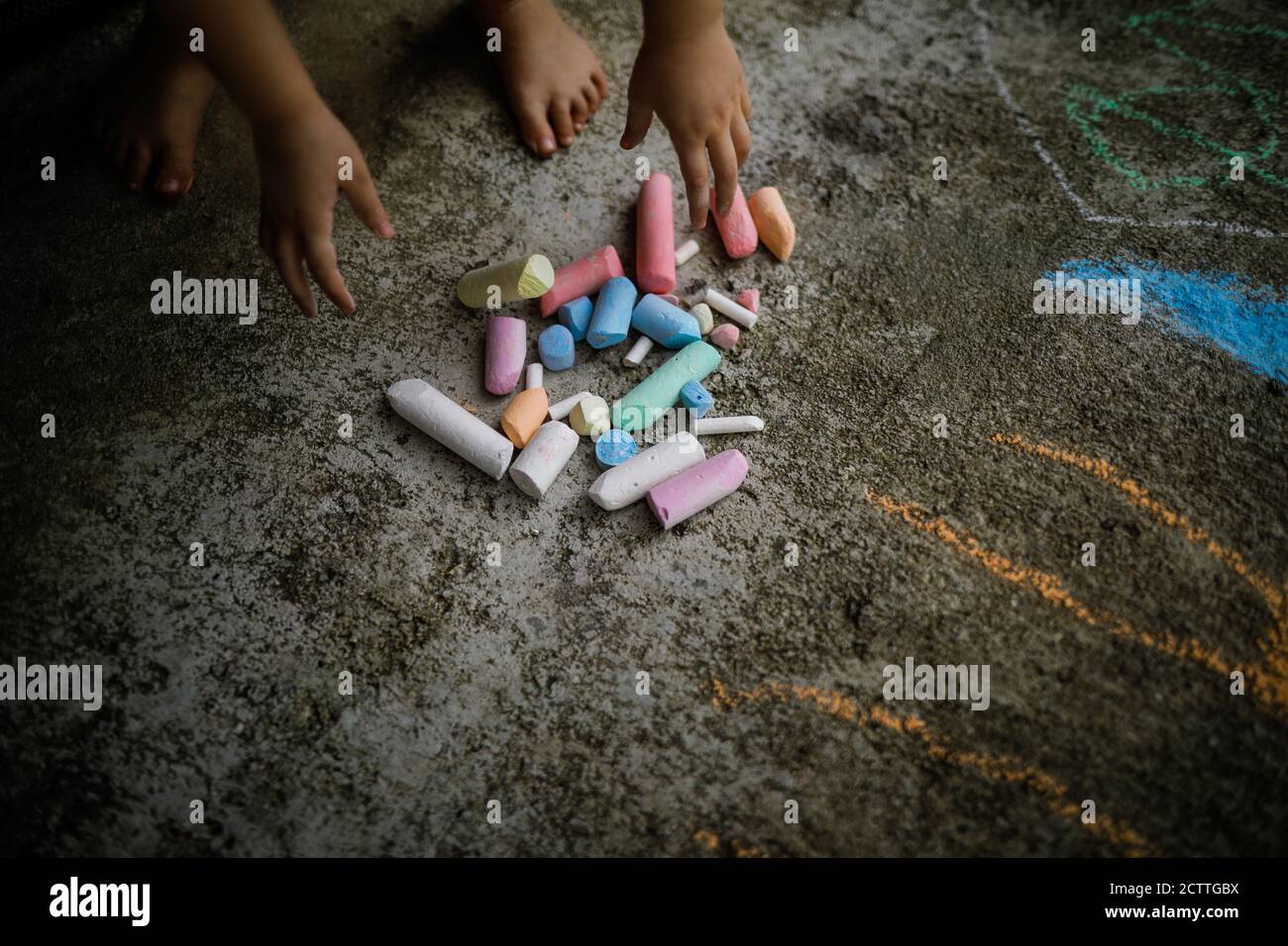 Children drawing on a pavement with chalk hi-res stock photography and ...