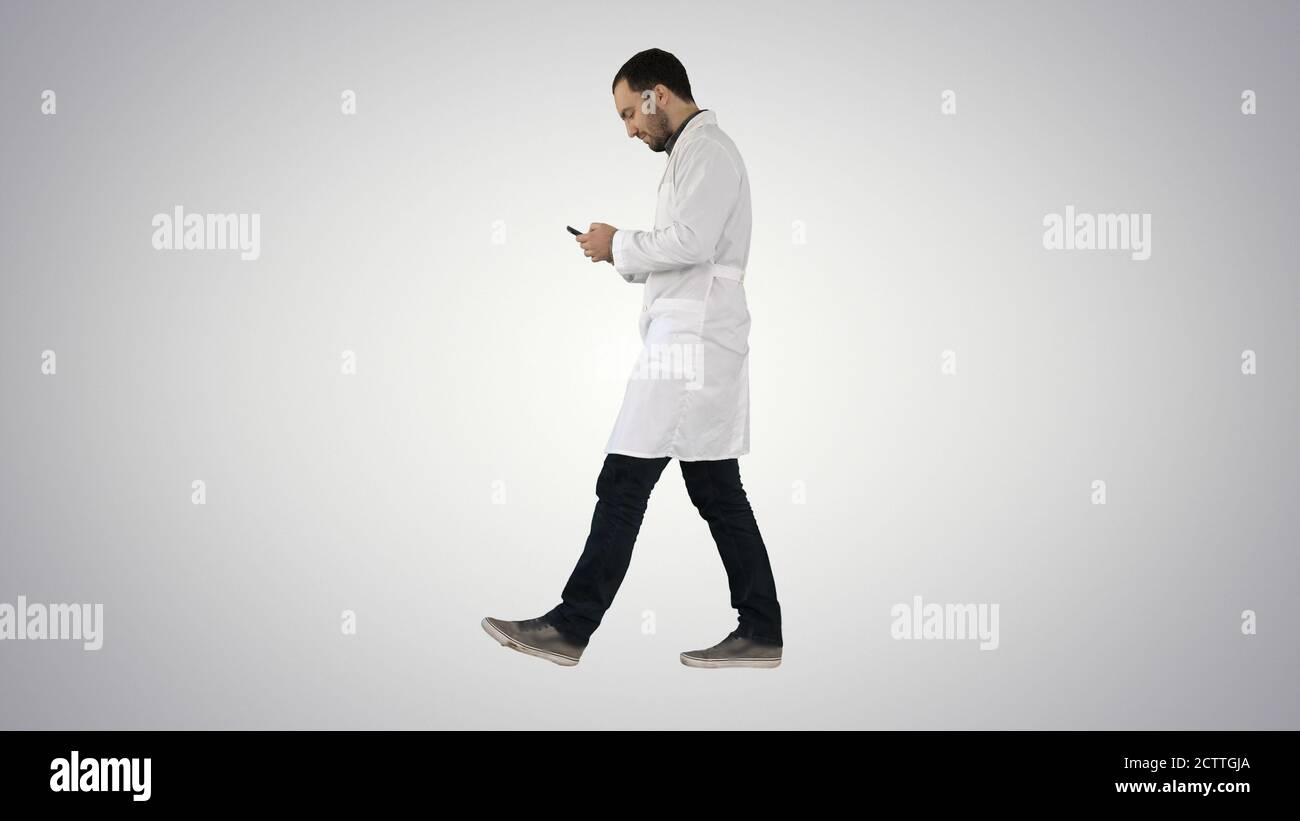 Walking medical professional using smart phone and making attant Stock Photo