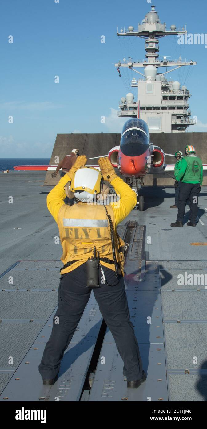 Aviation Boatswain’s Mate (Handler) 2nd Class Jynishia Hines from Lakeland, Florida, assigned to USS Gerald R. Ford's (CVN 78) air department, directs a-T-45C Goshawk, attached to Training Air Wing 2, as it prepares to launch from the flight deck Sept. 11, 2020. Ford is underway in the Atlantic Ocean conducting carrier qualifications. (U.S. Navy photo by Mass Communication Specialist Seaman Apprentice Sarah Mead) Stock Photo