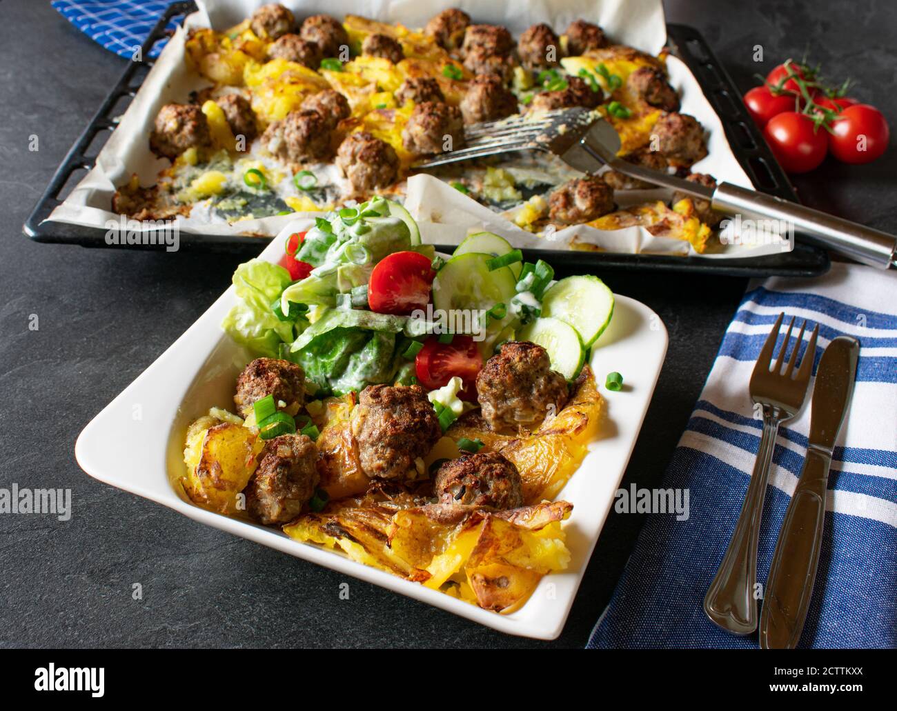 sheet meal with meatballs potatoes and vegetables Stock Photo