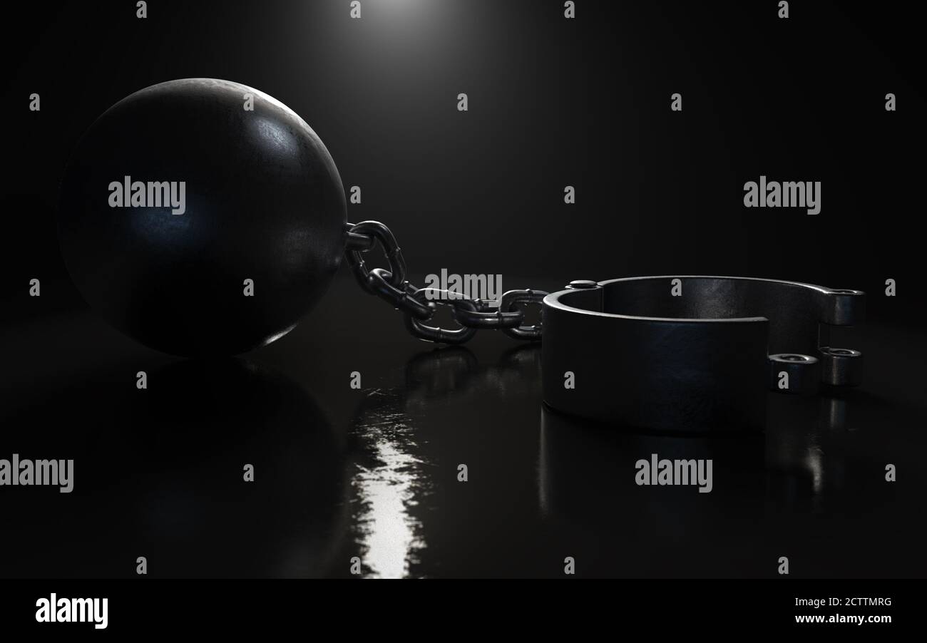 A heavy metal ball and chain with an opened shackle on an isolated dark