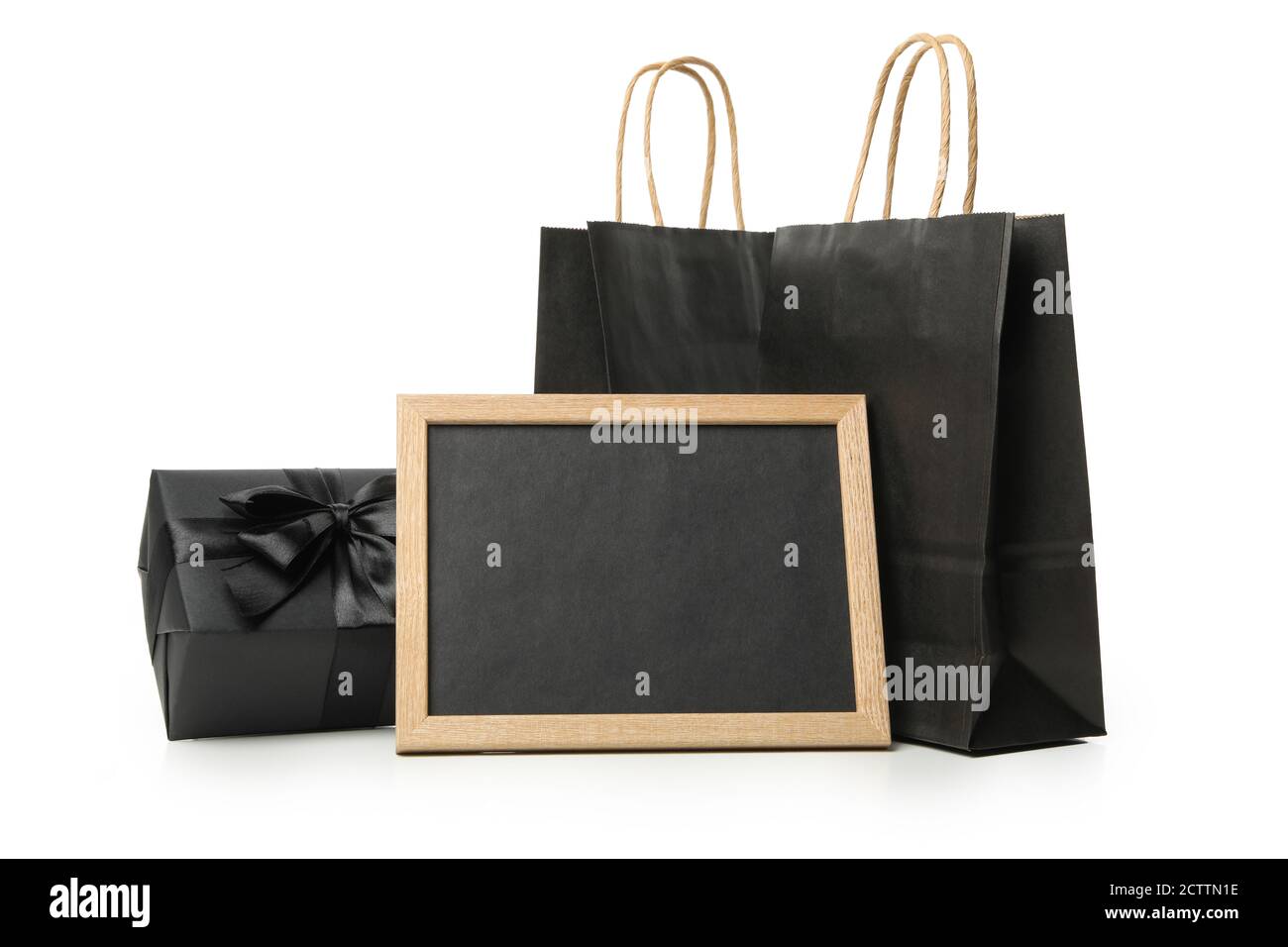 Paper bags, chalkboard and gift box isolated on white background Stock