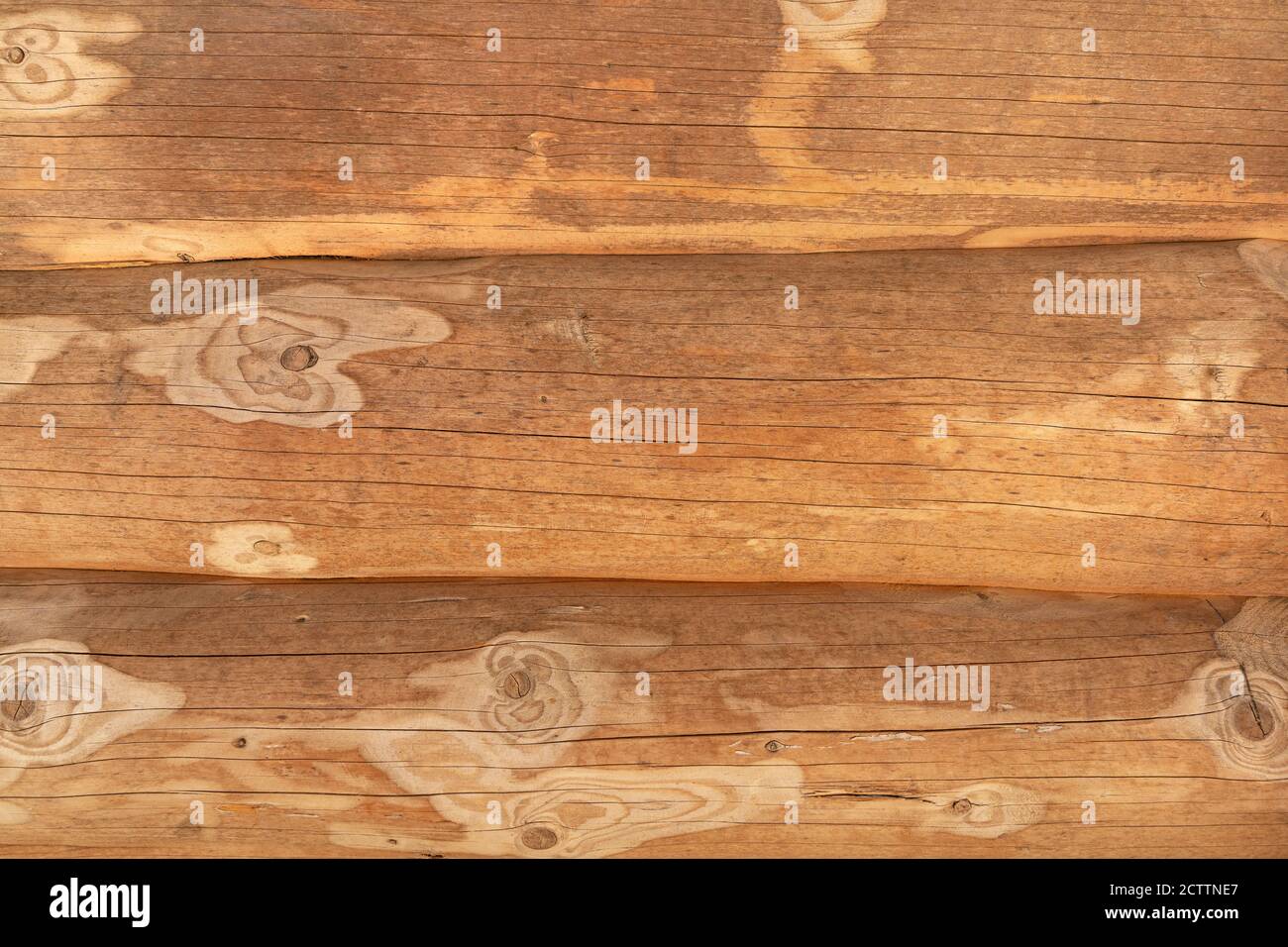 Closeup of three tree trunks of a log house lying on top of each other Stock Photo