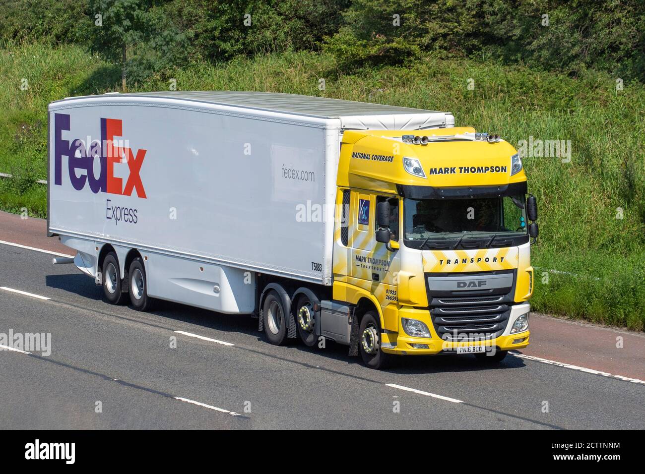 FedEx Express Haulage delivery trucks, lorry, heavy-duty vehicles,transportation, truck, cargo carrier, vehicle, European commercial transport industry HGV, M6 at Manchester, UK Stock Photo