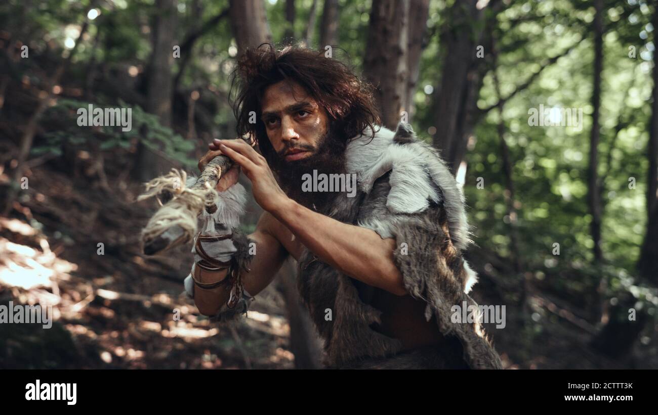 Portrait Of Primeval Caveman Wearing Animal Skin And Fur Hunting With A ...