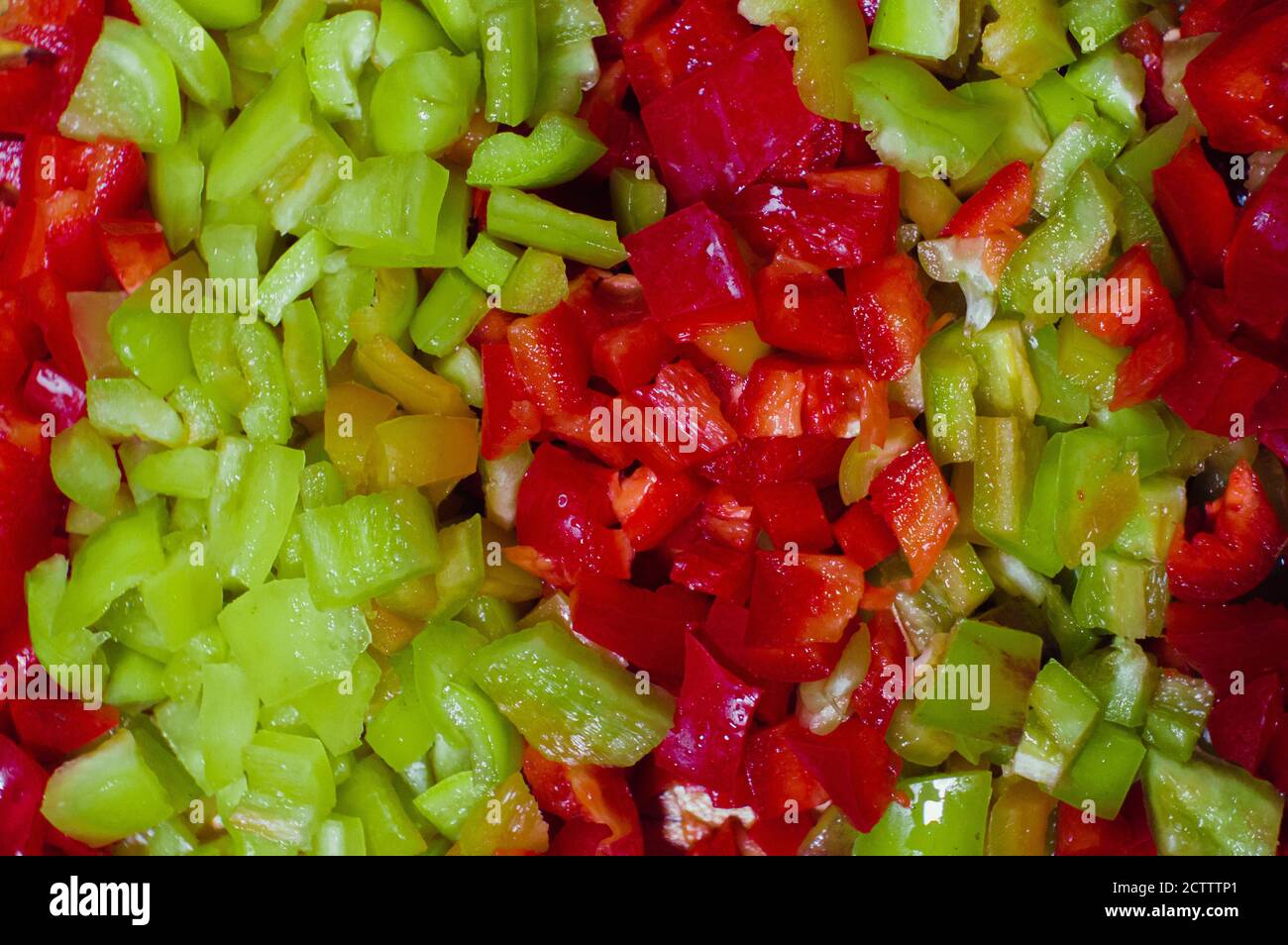 Red and green paprika cut into small pieces Stock Photo