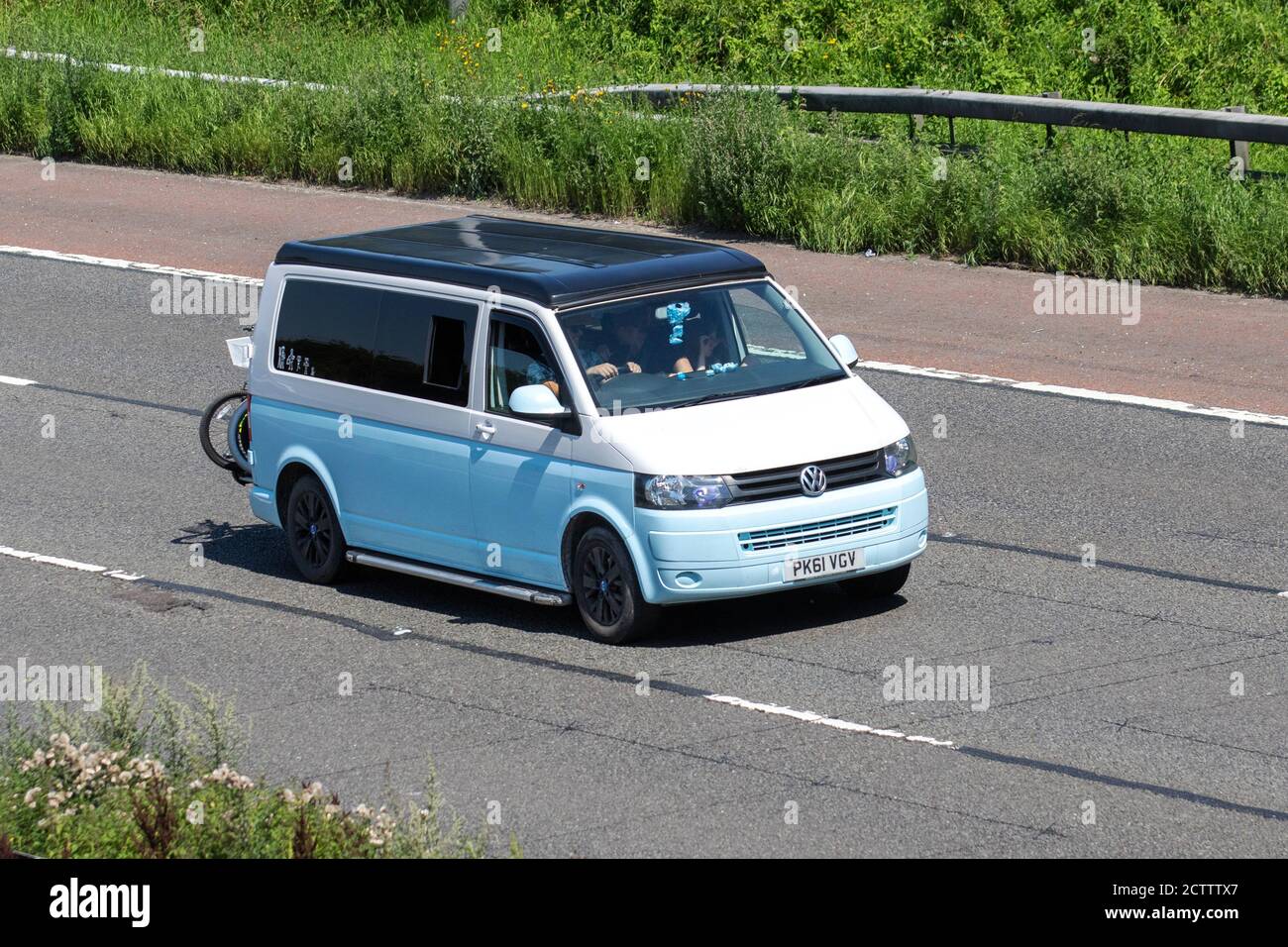 2011 blue white VW Volkswagen T-Sporter T30 102 TDI LWB; Caravans and Motorhomes, campervans on Britain's roads, RV leisure vehicle, family holidays, caravanette vacations, Touring caravan holiday, van conversions, Vanagon autohome, life on the road, Stock Photo