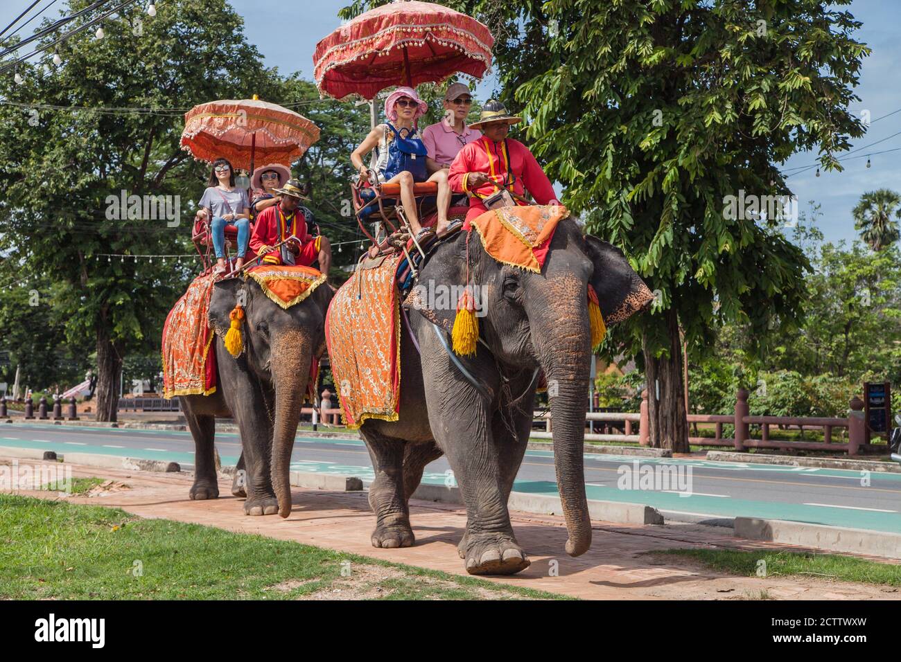 Ayutthaya, Thailand - August 31, 2018: Tourists on an elephant ride tour in the Historical Park of Ayutthaya, Thailand. Stock Photo