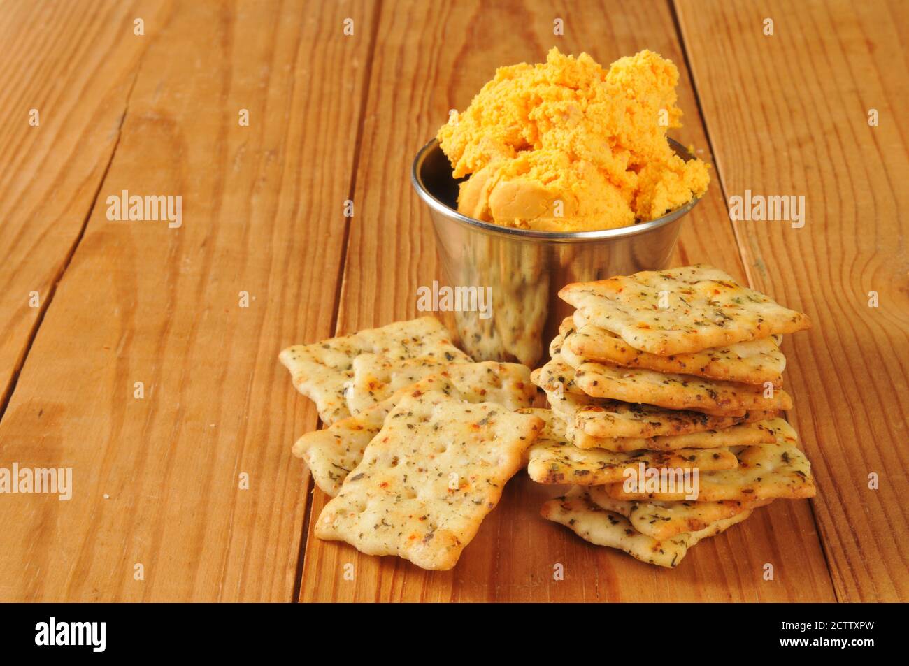 Italian herb flatbread crackers with bacon cheddar cheese spread on a