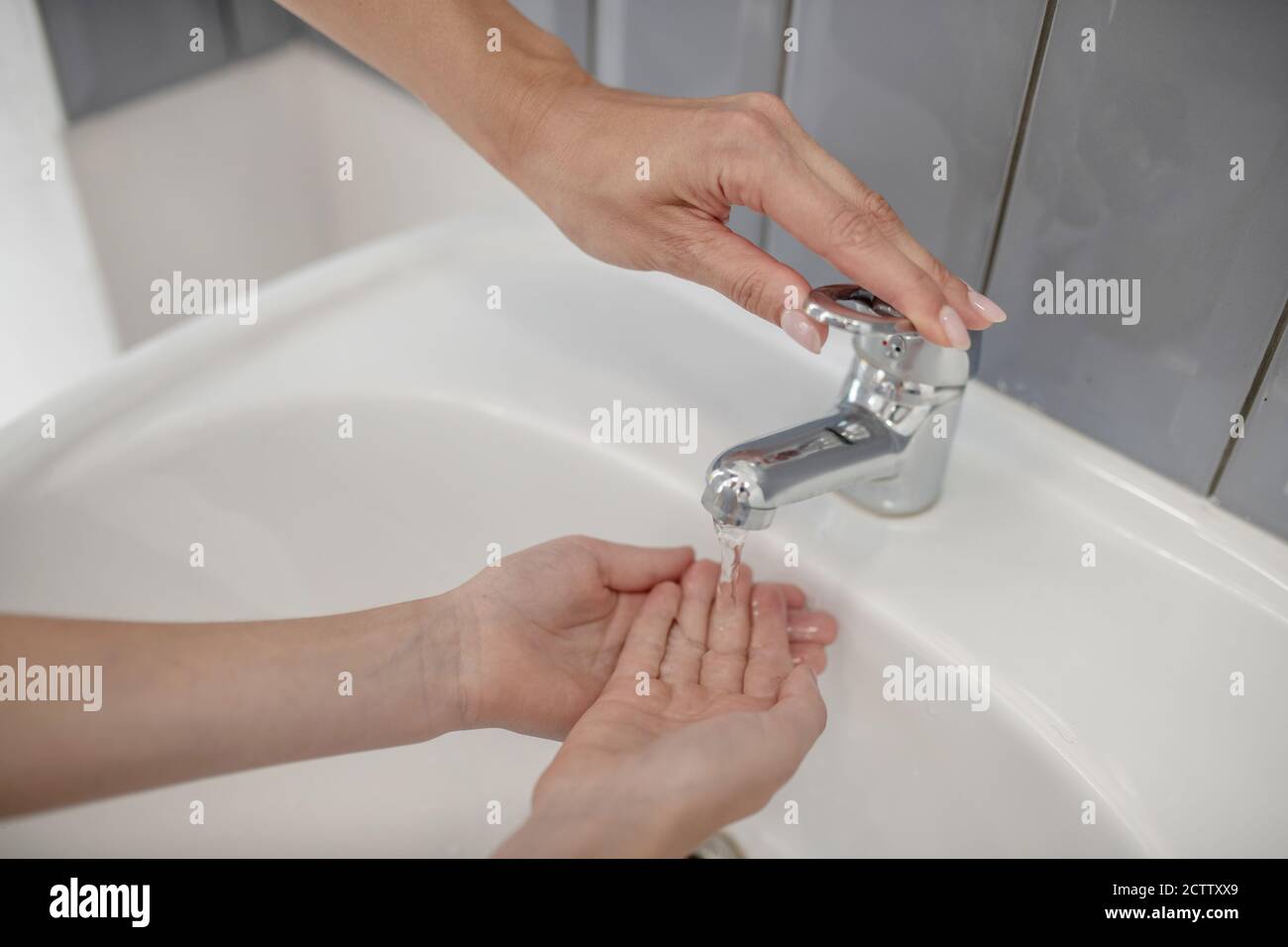 Close up picture of a kid washing hands in the bathroom Stock Photo