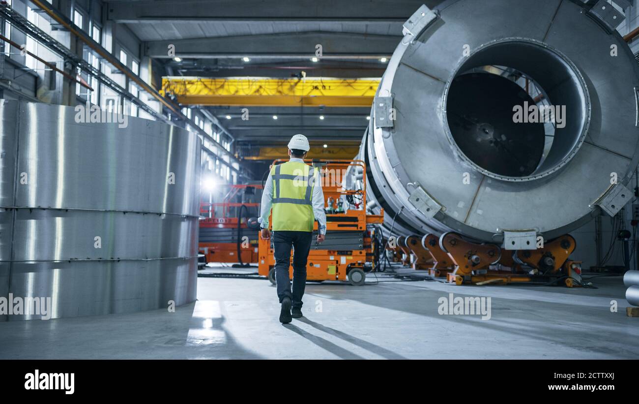 Following Shot of Heavy Industry Engineers Walking Through ...