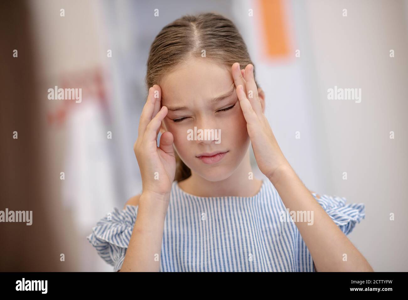 Girl having a headache and looking unhappy Stock Photo